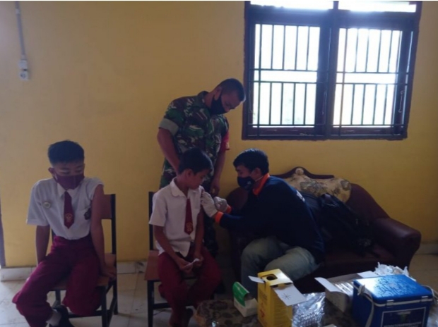 Babinsa Memonitor Vaksinasi Siswa -Siswi Sekolah Dasar Napal Melintang